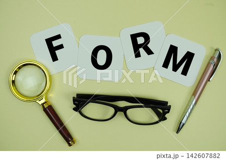 FORM alphabet letters with magnifying glass, eye glasses and pen on yellow background 142607882
