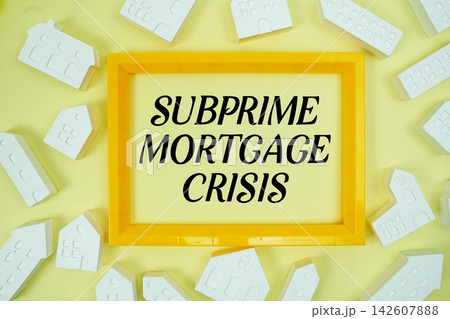 Subprime Mortgage Crisis text with house models on yellow background Subprime Mortgage Crisis text with house models on yellow background 142607888