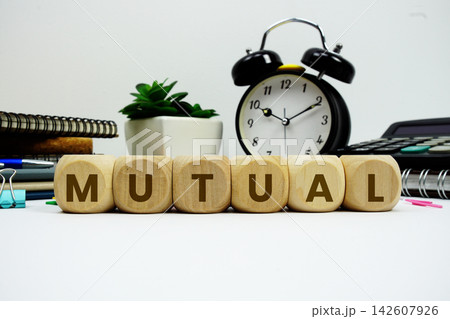 MUTUAL alphabet letters with alarm clock and calculator on white background MUTUAL alphabet letters with alarm clock and calculator on white background 142607926