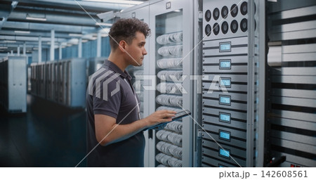 IT Specialist Inspecting Server Cabinet Hardware with Digital Tablet IT Specialist Inspecting Server Cabinet Hardware with Digital Tablet 142608561