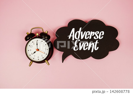 Adverse Event text on speech bubble with alarm clock on pink background 142608778
