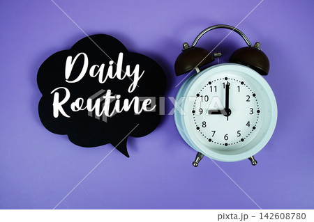 Daily Routine text on speech bubble with alarm clock on purple background Daily Routine text on speech bubble with alarm clock on purple background 142608780