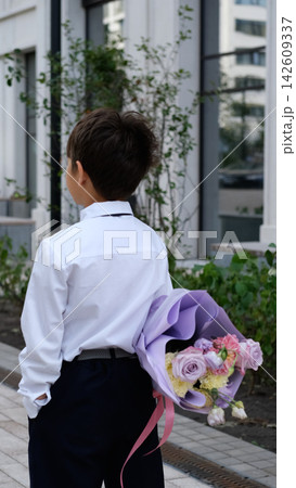 Schoolboy Carrying a Bouquet for His Teacher on September 1, First Day of School, Back to School, Knowledge Day and Beginning of the Academic Year 142609337