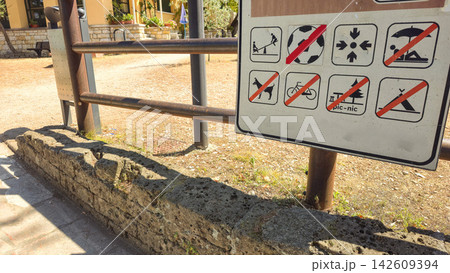 Public rules sign uses pictograms to show prohibited activities in an outdoor recreation area. Concepts: public safety, regulations, visitor guidance, responsible tourism, behavior, recreation 142609394