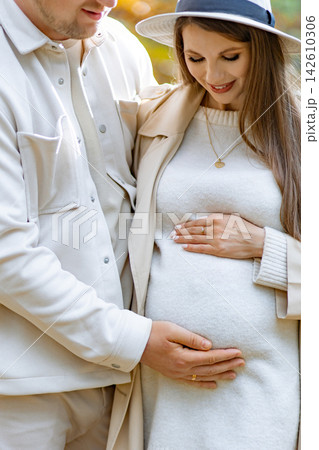 A loving couple embraces, the woman cradling her baby bump with tenderness and joy A loving couple embraces, the woman cradling her baby bump with tenderness and joy 142610306