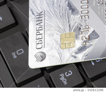 Credit card lying on black computer keyboard Credit card lying on black computer keyboard 142611200