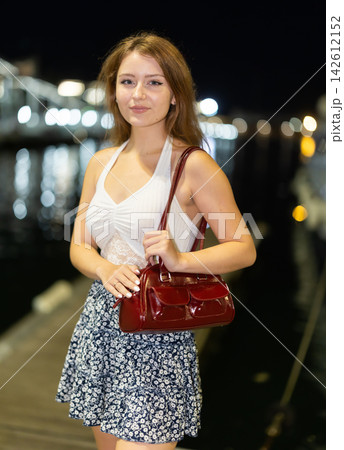 Evening portrait of girl against background of port in Vell in Barcelona. Yachts and boats Evening portrait of girl against background of port in Vell in Barcelona. Yachts and boats 142612152