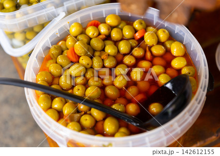 Green pitted olives with carrots and garlic in bucket 142612155