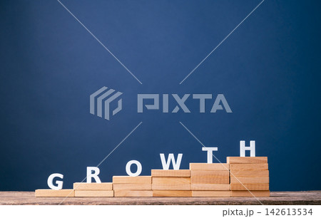 Business growth and step-by-step progress with GROWTH letters on rising wooden stairs Business growth and step-by-step progress with GROWTH letters on rising wooden stairs 142613534
