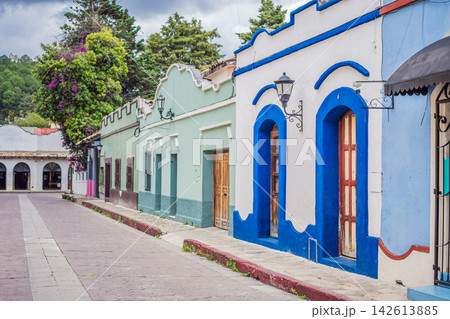 Colorful colonial street showing traditional buildings and mountain town atmosphere in San Cristobal de las Casas Chiapas Mexico with painted facades cobblestone historic center Mexican. 142613885