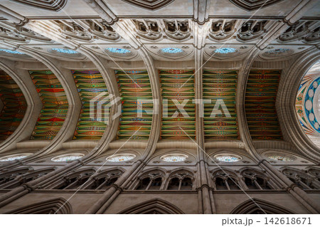 Intricate geometric painted ceiling panels along the ribbed vaults of Almudena Cathedral Intricate geometric painted ceiling panels along the ribbed vaults of Almudena Cathedral 142618671
