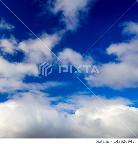 contrasting blue sky with fluffy white cloud mass at the lower part of the image framing contrasting blue sky with fluffy white cloud mass at the lower part of the image framing 142620945