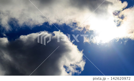 bright sun breaking through a dark cumulus cloud bright sun breaking through a dark cumulus cloud 142620972