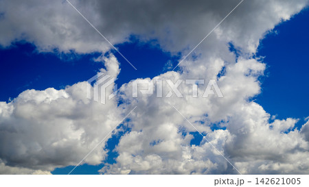 dense white clouds covering blue sky 142621005