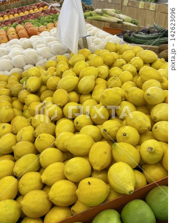 Fresh lemons on display at supermarket produce section 142623096
