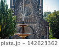 Fountain in Prague with church in background during bright sunny day 142623362