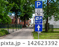Road signs indicating parking options and nearby facilities in a city area 142623392