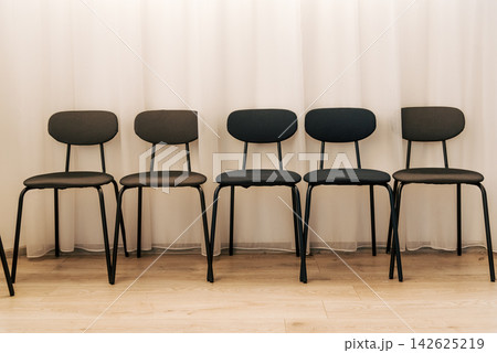 Black chairs on background of white transparent tulle curtains sunset sunlight Black chairs on background of white transparent tulle curtains sunset sunlight 142625219