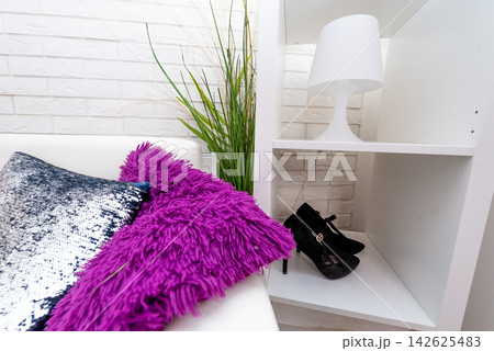 Colored soft pillows on sofa, cozy interior of hotel apartment living room Colored soft pillows on sofa, cozy interior of hotel apartment living room 142625483