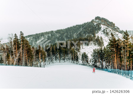 Snowboarder skier sliding down snowy slope Snowboarder skier sliding down snowy slope 142626306