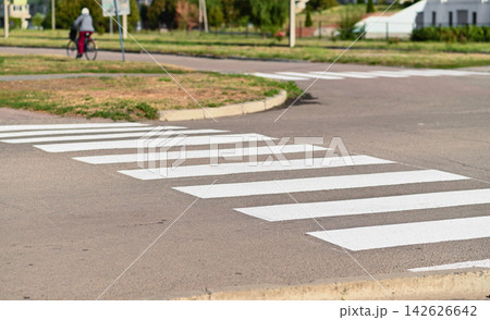 Pedestrian crossing marks white stripes on asphalt road surface. Pedestrian crossing marks white stripes on asphalt road surface. 142626642