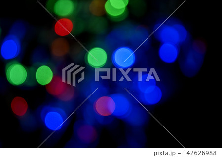 Colorful bokeh lights in blue, green, orange, and red on a dark background. Abstract festive texture. Abstract holiday illumination and decoration background Colorful bokeh lights in blue, green, orange, and red on a dark background. Abstract festive texture. Abstract holiday illumination and decoration background 142626988