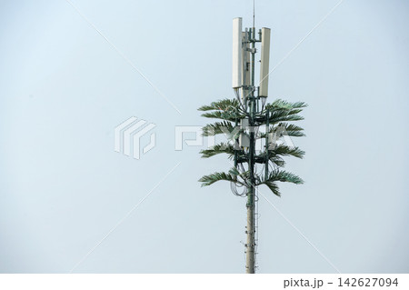 Telecommunication cell tower antenna against a blue sky with clouds. Concept of communication network and connection technology 142627094