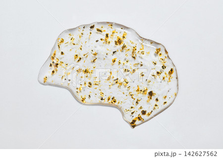 Gold leaf particles suspended in transparent cosmetic serum smear 142627562