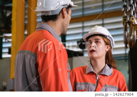 The engineer checks the parts coming out of the machine. The engineer checks the parts coming out of the machine. 142627904