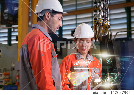 The engineer checks the parts coming out of the machine. The engineer checks the parts coming out of the machine. 142627905