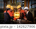 The engineer checks the parts coming out of the machine. 142627906