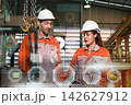 The engineer checks the parts coming out of the machine. 142627912