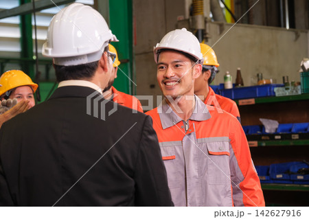 The engineer checks the parts coming out of the machine. The engineer checks the parts coming out of the machine. 142627916