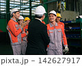 The engineer checks the parts coming out of the machine. 142627917