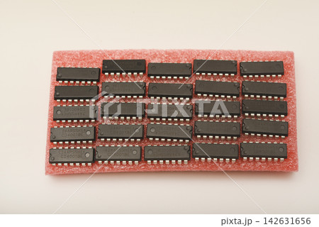 Microchips on red foam. Chip packaging. Microchips in a DIP package. Microchips on red foam. Chip packaging. Microchips in a DIP package. 142631656