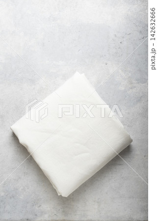 Folded Off White Linen Fabric on Concrete Surface 142632666