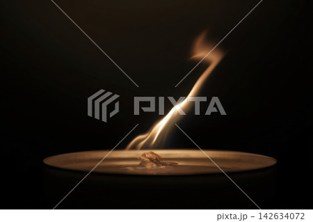 Flame bending under invisible airflow creating dynamic motion in dark setting Flame bending under invisible airflow creating dynamic motion in dark setting 142634072