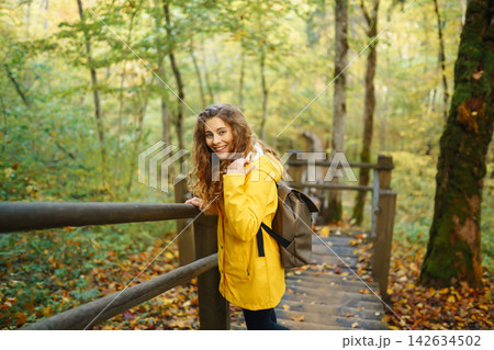 Portrait of young woman walking in the forest. Travelling, lifestyle, adventure. Portrait of young woman walking in the forest. Travelling, lifestyle, adventure. 142634502