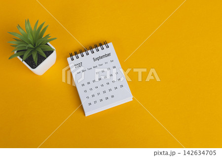 The September 2027 desk calendar with potted plant on yellow background. The September 2027 desk calendar with potted plant on yellow background. 142634705