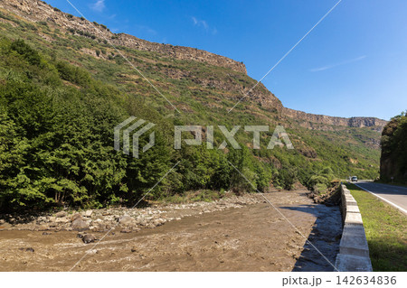 A scenic roadside view of a muddy river A scenic roadside view of a muddy river 142634836