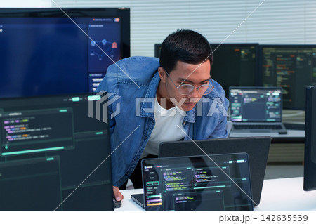 Programmer Developing Digital Software with Code and AI Technology Programmer Developing Digital Software with Code and AI Technology 142635539