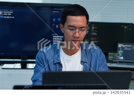 Focused Programmer Working on Software Development 142635541