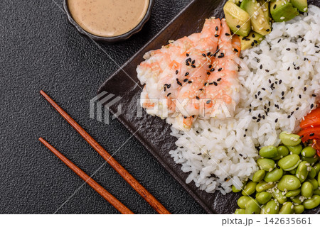 An Asian style bowl with shrimp, edamame, tomatoes, and wakame. A shrimp and vegetable bowl 142635661