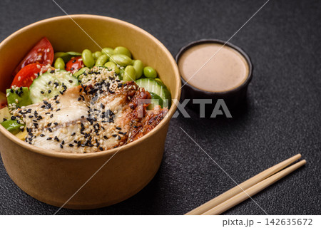 An Asian style bowl with eel, edamame, avocado, tomatoes, and lettuce. A eel and vegetable bowl An Asian style bowl with eel, edamame, avocado, tomatoes, and lettuce. A eel and vegetable bowl 142635672