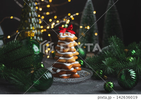 Christmas Star Shaped Gingerbread Cookies Stacked Like Tree With Festive Decorations Lights And Pine Branches Christmas Star Shaped Gingerbread Cookies Stacked Like Tree With Festive Decorations Lights And Pine Branches 142636019