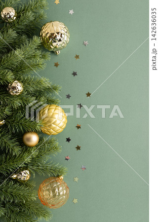 Festive Christmas Tree Branches With Golden Ornaments And Star Confetti On A Soft Green Background With Copy Space Festive Christmas Tree Branches With Golden Ornaments And Star Confetti On A Soft Green Background With Copy Space 142636035
