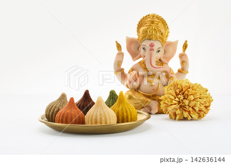Lord ganesha idol with colorful modak sweets celebrating chaturthi festival Lord ganesha idol with colorful modak sweets celebrating chaturthi festival 142636144