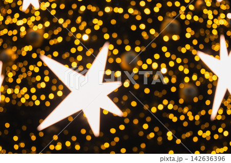 Glowing Christmas stars with golden bokeh lights Glowing Christmas stars with golden bokeh lights 142636396