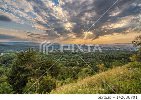 View of the mountains and Kislovodsk from the observation decks of the Kislovodsk Park. Evening sunset over the mountains of Kislovodsk. View of the mountains and Kislovodsk from the observation decks of the Kislovodsk Park. Evening sunset over the mountains of Kislovodsk. 142636701
