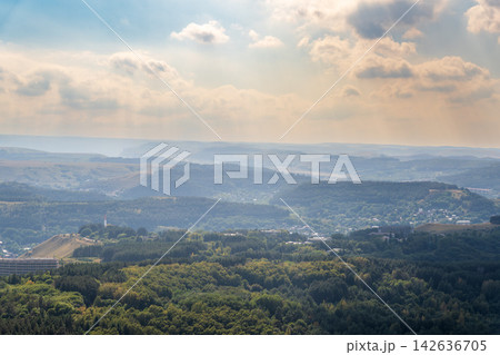 Layers of green mountains and hills in the haze during sunset. Panoramic View of Green hills and Meadow. 142636705